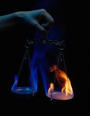 Balancing fire and ice with a scale in a dark setting
