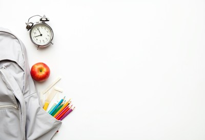 School supplies arranged on a white surface for class