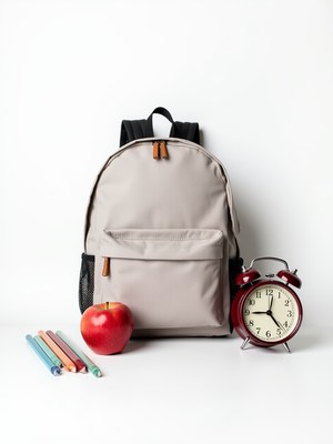 Backpack with apple and clock on a white background