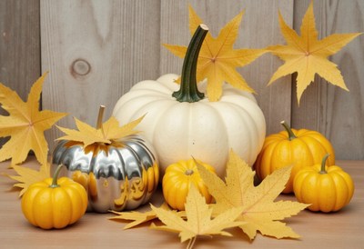 Fall decor arranged with pumpkins and autumn leaves