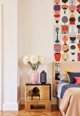 Modern bedroom decor with floral arrangement and art wall