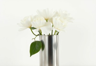 White flowers in a stainless steel vase on white background