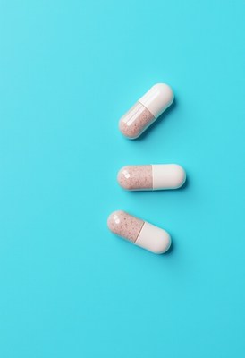 Three pills on bright blue background