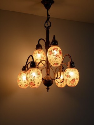 Elegant floral chandelier lighting up a cozy room