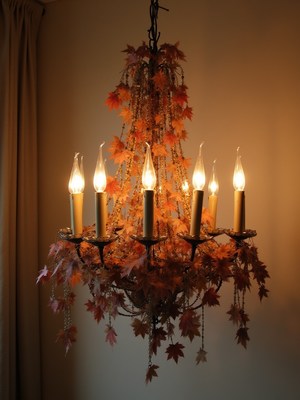 Beautiful autumn chandelier with warm lighting in room