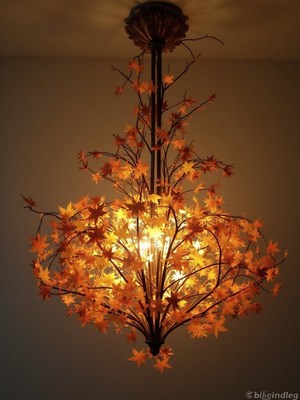 Charming autumn leaf chandelier illuminates cozy space