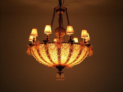 Elegant chandelier with warm light in a cozy room