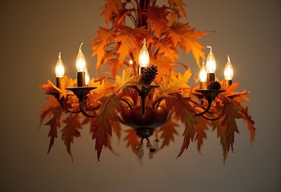 Warm autumn chandelier with glowing lights and leaves