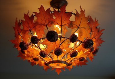Chandelier adorned with autumn leaves and pinecones