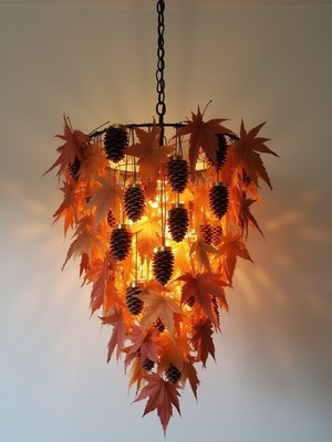 Unique chandelier made with pinecones and autumn leaves