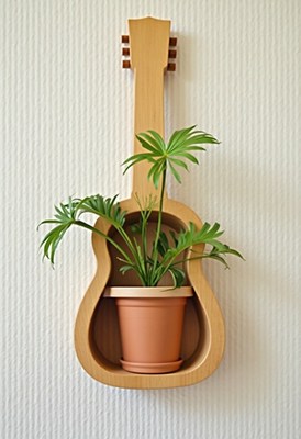 Unique wall decoration with guitar and potted plant