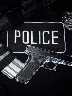 Police gear includes firearm and badge on uniform