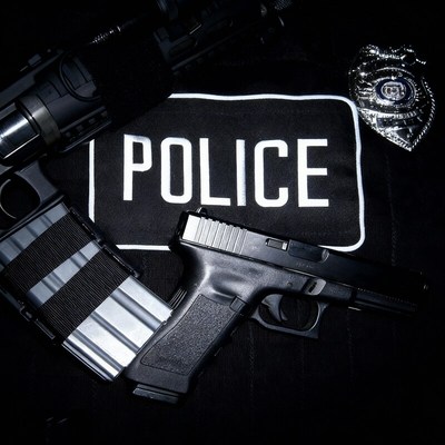 Police equipment displayed on a tactical vest with badge