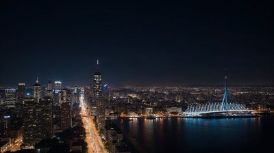 City skyline at night with illuminated buildings and bridge