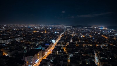 City skyline illuminated at night from a high vantage point