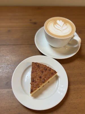 Delicious latte and dessert on a wooden table