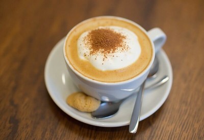 Creamy coffee topped with spices served in a cup