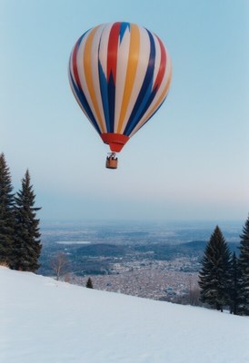 Colorful hot air balloon soaring over snowy landscape