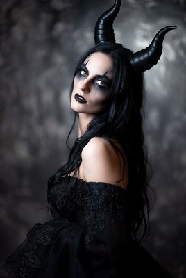 Dark fantasy figure with horns in dramatic lighting