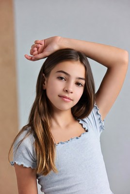 Girl poses with confidence in stylish blue top