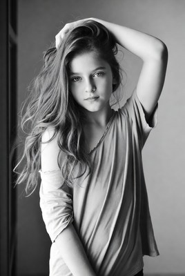 Young girl poses in a casual setting with long hair