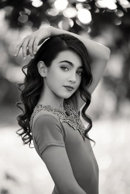 Young girl posing gracefully in a natural setting