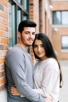 Couple embraces in urban setting on a sunny day
