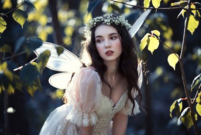 Fairy in enchanting forest surrounded by lush greenery