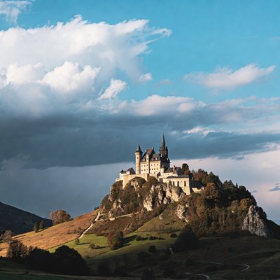 Majestic castle on a hill under dramatic skies
