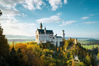 Beautiful castle on a hill surrounded by autumn trees