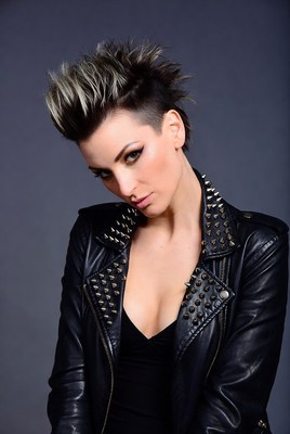 Stylish woman with punk hairstyle poses in leather jacket