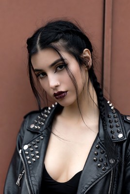 Confident young woman in stylish leather jacket