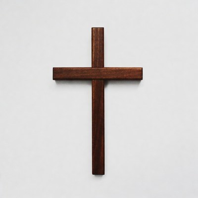 Wooden cross against a plain background in soft light