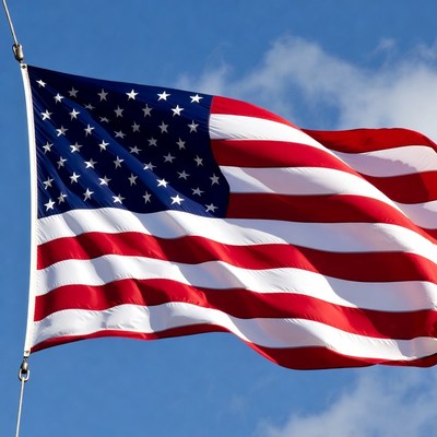 Waving american flag against a clear blue sky