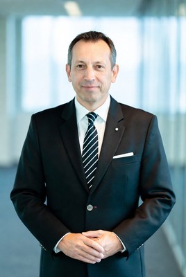 Business professional standing confidently in office setting