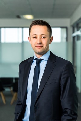 Business professional in formal attire standing confidently