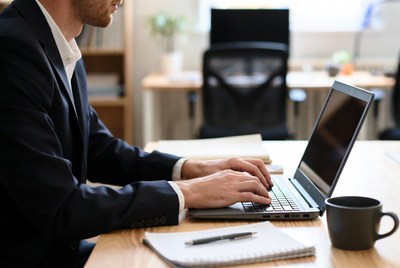 Professional man working on laptop in modern office space