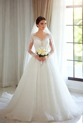 Beautiful bride in elegant wedding dress standing indoors