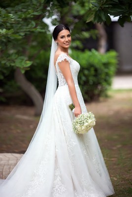 Beautiful bride smiling in a garden with a bouquet
