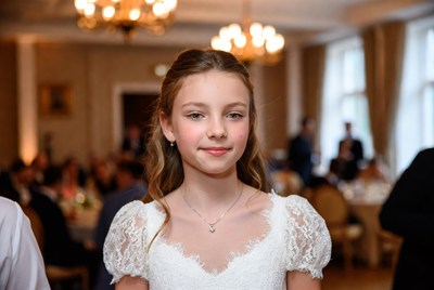 Girl in elegant dress at formal event in a grand hall