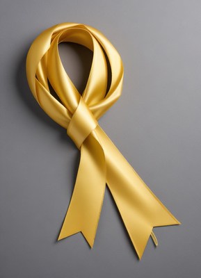 Yellow ribbon tied in a loop on gray background