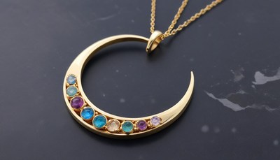 Beautiful golden crescent moon pendant with colorful gems