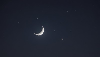 Crescent moon shining in a dark night sky