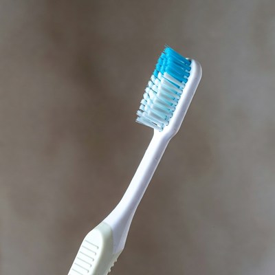 Simple white toothbrush with blue bristles