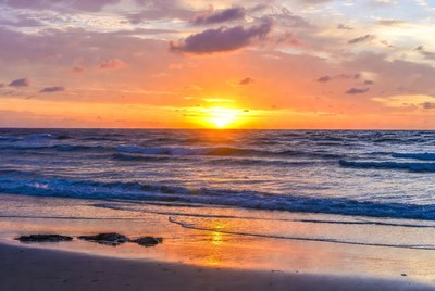 Sunset over calm ocean waves