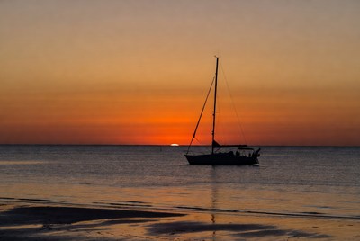 Sailing at sunset by the beach