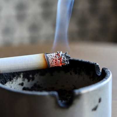 Smoking cigarette in ashtray closeup