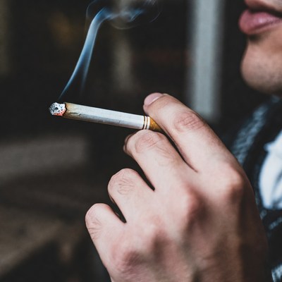 Man smoking a cigarette indoors