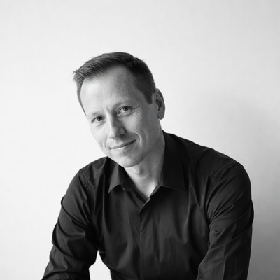 Man in black shirt smiles