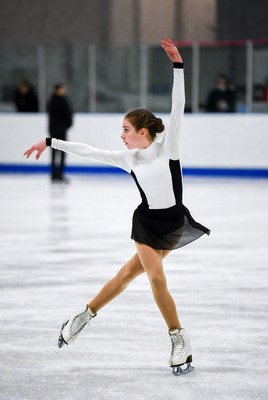 Young skater performs at competition